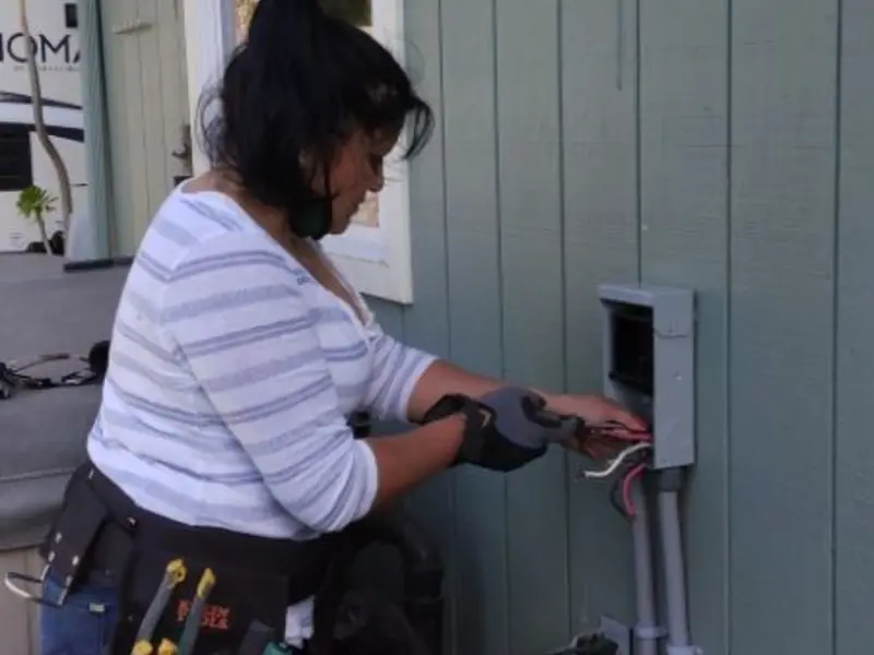 Licensed electrician wiring an exterior subpanel in Hope